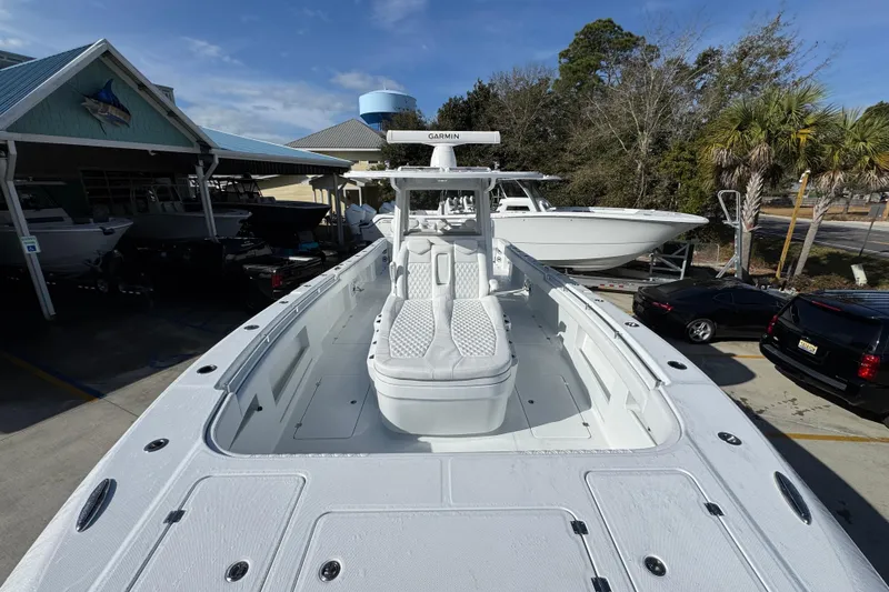 Slide: The Image of 2026 Invincible 36 Catamaran with sleek design, docked at a marina under clear skies. - 19