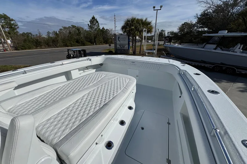 Slide: The Image of 2026 Invincible 36 Catamaran with white quilted seating, docked outdoors. - 21