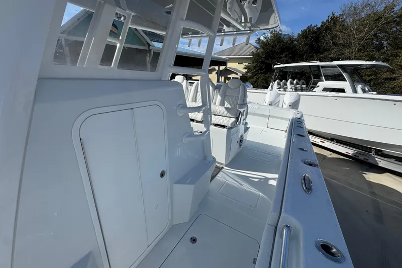 Slide: The Image of 2026 Invincible 36 Catamaran interior with sleek white seating and modern design. - 24