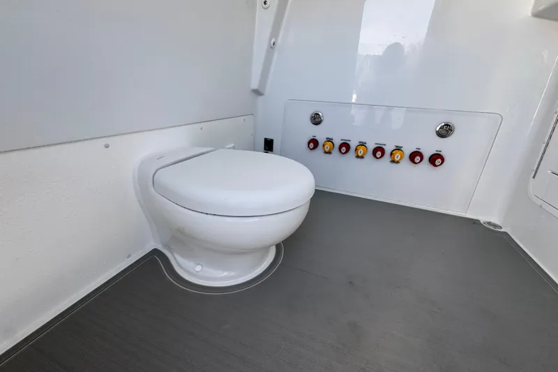 Slide: The Image of 2026 Invincible 36 Catamaran interior with modern marine toilet and control panel. - 28