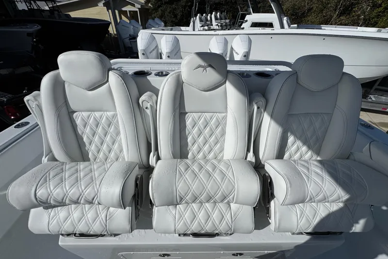 Slide: The Image of Luxurious seating on 2026 Invincible 36 Catamaran, featuring elegant white upholstery and diamond stitching. - 30