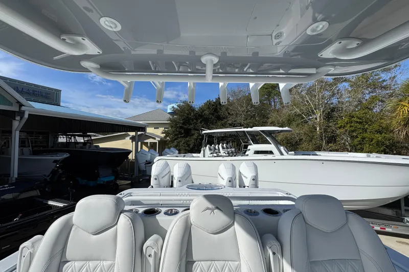 Slide: The Image of 2026 Invincible 36 Catamaran with luxurious seating and sleek design in a marina setting. - 31