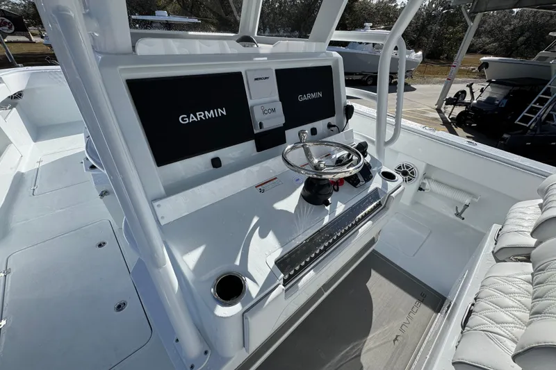 Slide: The Image of 2026 Invincible 36 Catamaran helm with Garmin displays and steering wheel. - 32