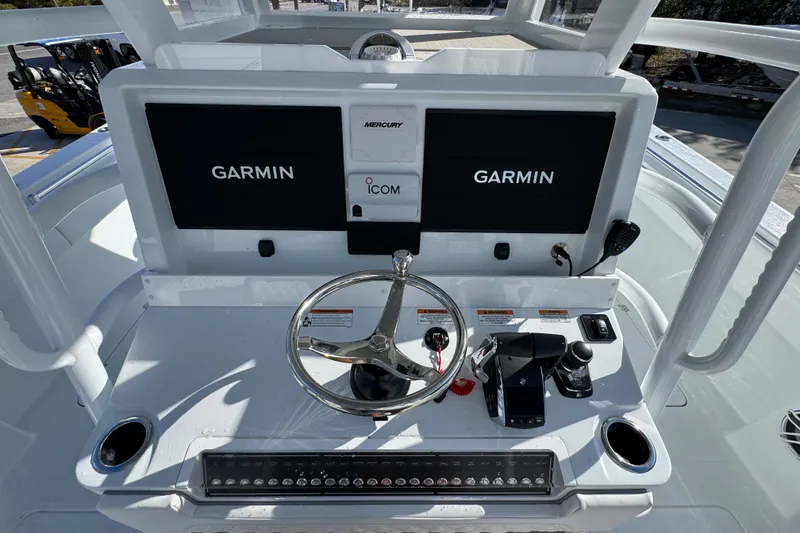 Slide: The Image of 2026 Invincible 36 Catamaran helm with Garmin displays and Mercury controls. - 33