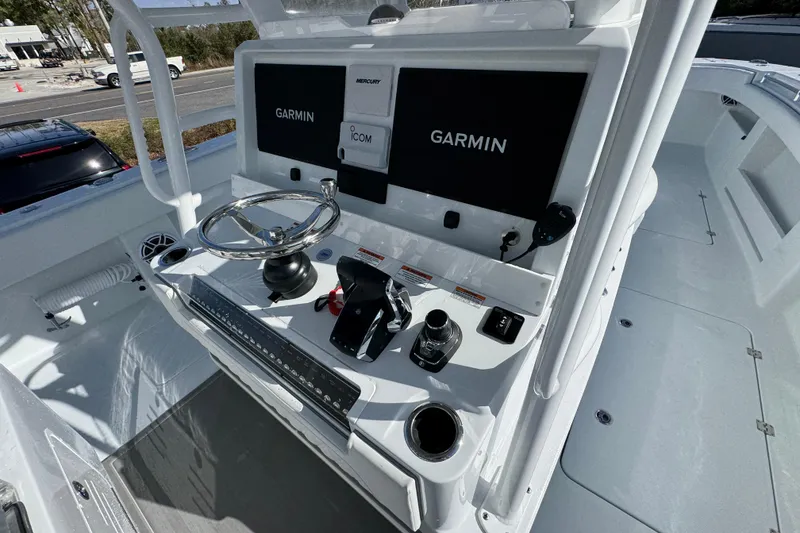 Slide: The Image of 2026 Invincible 36 Catamaran helm with Garmin navigation and Mercury controls. - 35