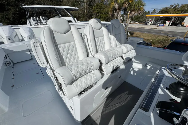 Slide: The Image of Luxury seating on 2026 Invincible 36 Catamaran, featuring plush white leather and modern design. - 36
