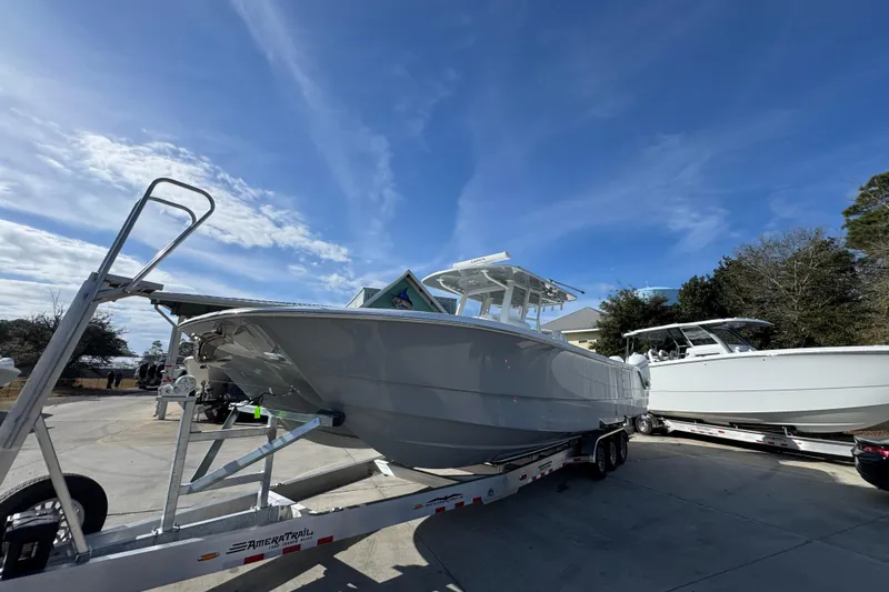 Slide: The Image of 2026 Invincible 36 Catamaran on trailer under clear blue sky. - 4