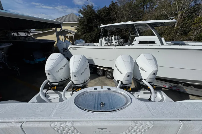 Slide: The Image of 2026 Invincible 36 Catamaran with four Mercury outboard engines in a marina setting. - 43