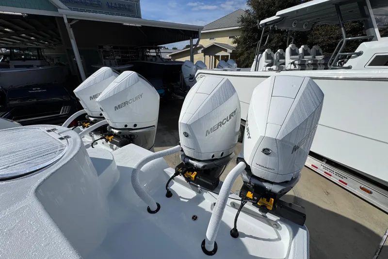 Slide: The Image of 2026 Invincible 36 Catamaran with four Mercury outboard engines at a marina. - 44