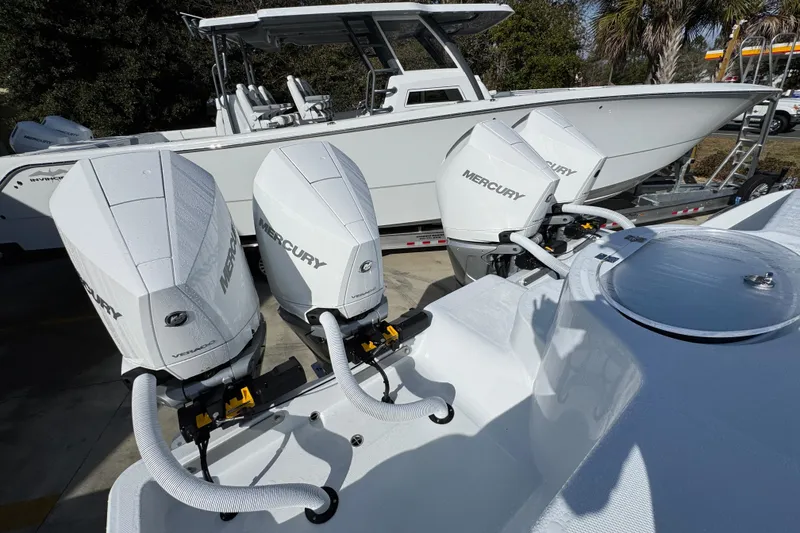 Slide: The Image of 2026 Invincible 36 Catamaran with four Mercury outboard engines, parked outdoors. - 45