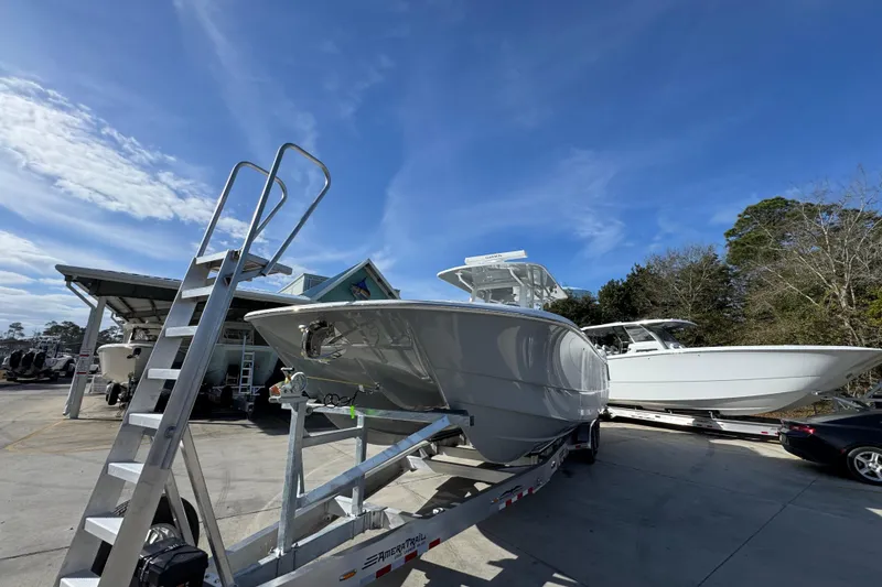 Slide: The Image of 2026 Invincible 36 Catamaran on trailer under clear blue sky. - 5