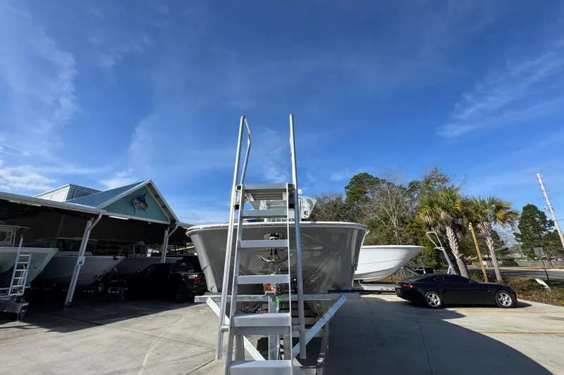 Slide: The Image of 2026 Invincible 36 Catamaran in a boatyard under clear blue skies. - 6