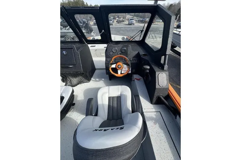 Slide: The Image of 2026 SeaArk ProCat 240 boat interior with steering wheel and cushioned seat. - 8