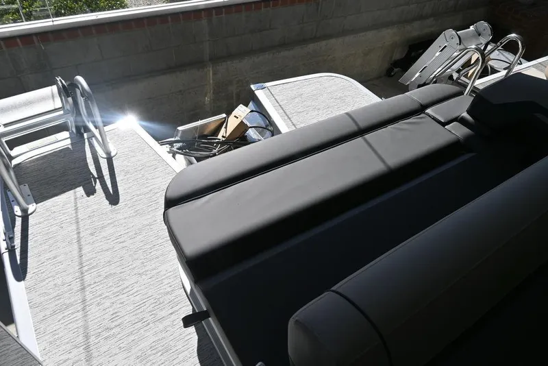 Slide: The Image of 2026 Bennington S Swingback 23 SSB boat interior with sleek seating and ladder. - 11