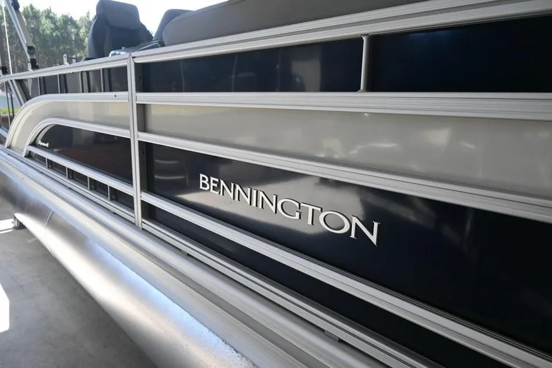 Slide: The Image of 2026 Bennington S Swingback 23 SSB pontoon boat, side view with logo. - 2