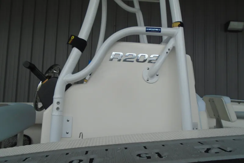 Slide: The Image of 2021 Robalo R202 Explorer boat interior with steering wheel and model name. - 10