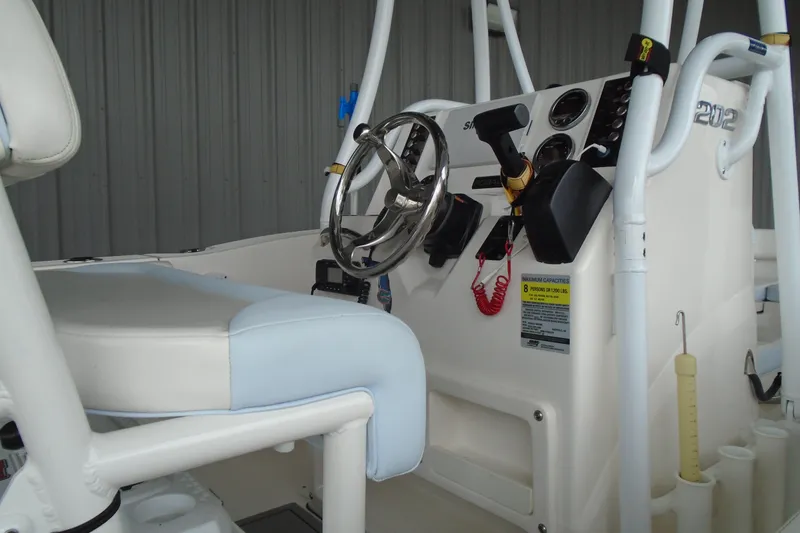 Slide: The Image of 2021 Robalo R202 Explorer boat interior with steering wheel and control panel. - 12