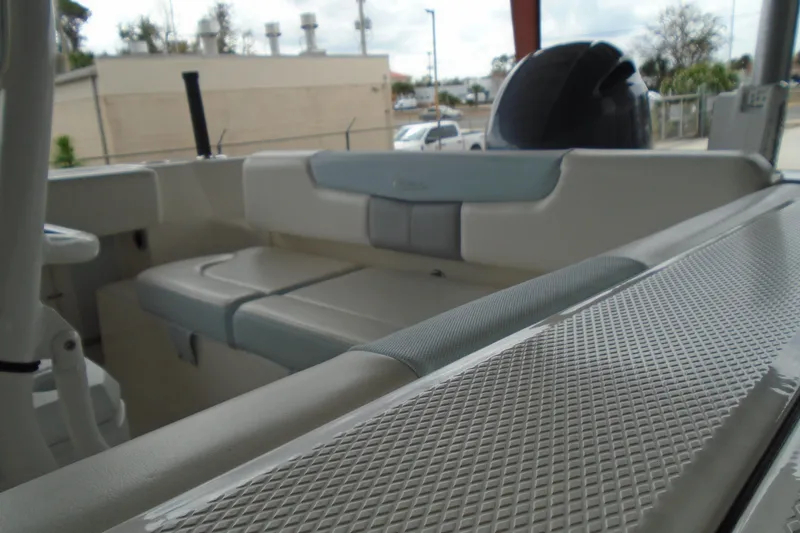 Slide: The Image of 2021 Robalo R202 Explorer boat interior with cushioned seating and sleek design. - 16