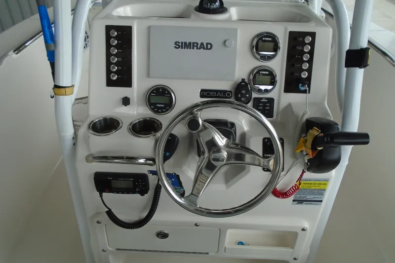 Slide: The Image of 2021 Robalo R202 Explorer boat dashboard with steering wheel and control panel. - 20
