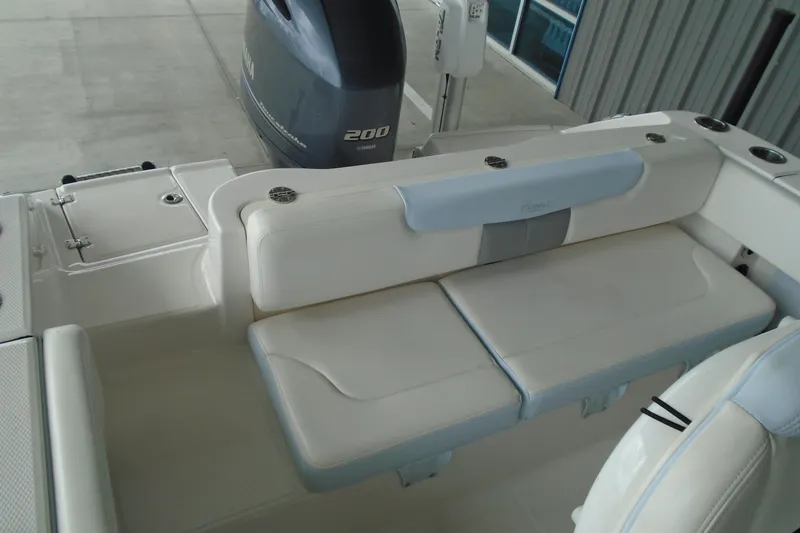 Slide: The Image of 2021 Robalo R202 Explorer boat interior with Yamaha 200 engine, featuring cushioned seating. - 24