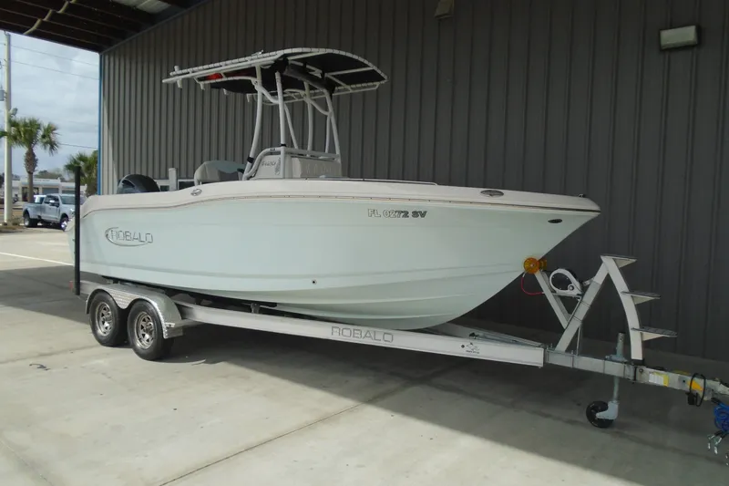 Slide: The Image of 2021 Robalo R202 Explorer boat on trailer, parked in covered area. - 5