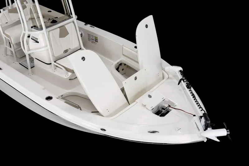 Slide: The Image of 2026 Robalo 206 Cayman boat interior with open storage compartments and trolling motor. - 7