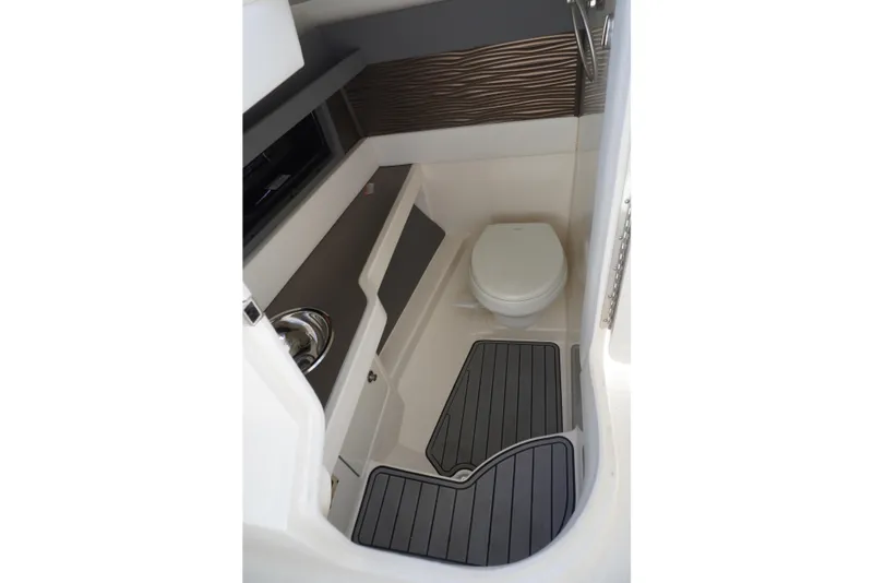 Slide: The Image of 2020 Sea Ray SLX 310 Outboard boat bathroom interior with toilet and sink. - 12