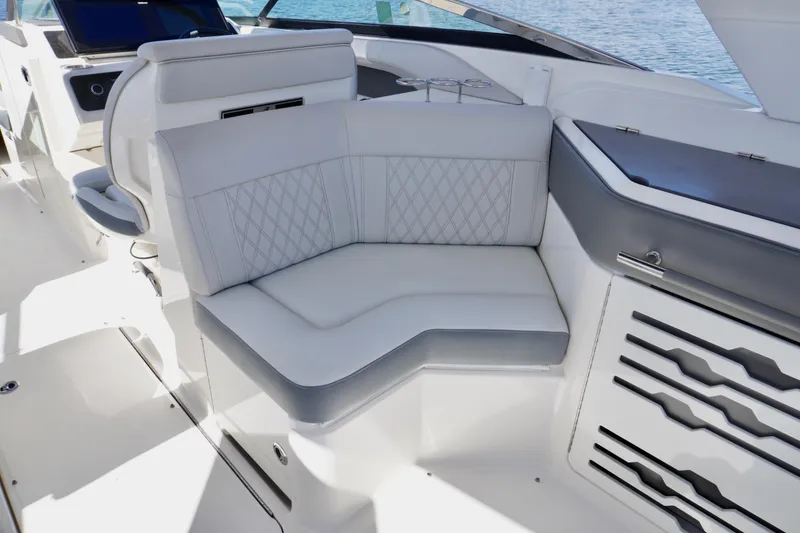 Slide: The Image of 2020 Sea Ray SLX 310 Outboard interior with luxurious seating and modern design. - 13