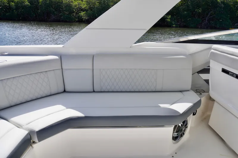 Slide: The Image of Luxurious seating on 2020 Sea Ray SLX 310 Outboard boat, featuring elegant white upholstery. - 15