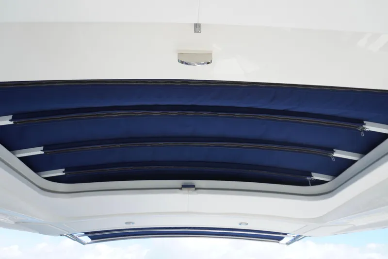 Slide: The Image of 2020 Sea Ray SLX 310 Outboard boat canopy, featuring blue retractable sunshade. - 19