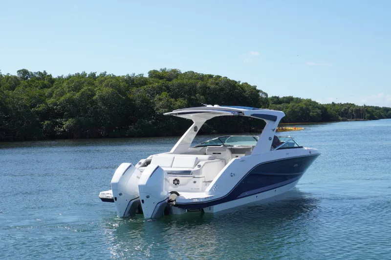 Slide: The Image of 2020 Sea Ray SLX 310 Outboard boat cruising on a serene waterway. - 4