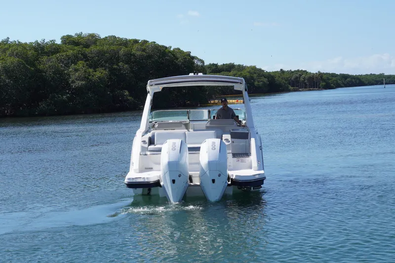 Slide: The Image of 2020 Sea Ray SLX 310 Outboard cruising on a serene waterway. - 5