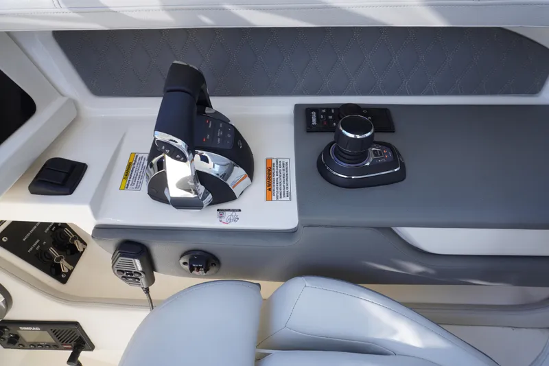 Slide: The Image of 2020 Sea Ray SLX 310 Outboard helm controls with joystick and throttle. - 8