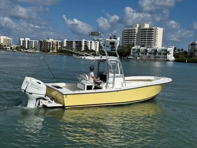 Slide: The Image of Yellow 2004 Regulator 26 Center Console boat on calm water. - 3