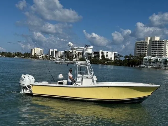 Slide: The Image of 2004 Regulator 26 Center Console boat on water near buildings. - 6