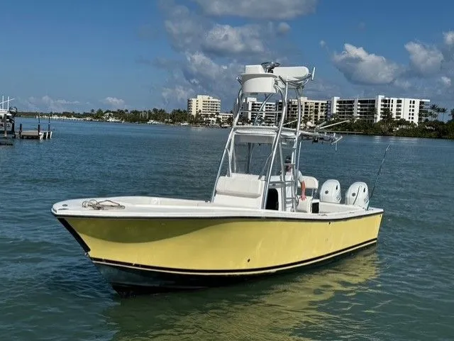 Slide: The Image of 2004 Regulator 26 Center Console boat on calm water. - 8