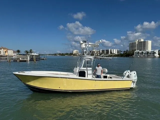 Slide: The Image of 2004 Regulator 26 Center Console boat on calm water. - 9
