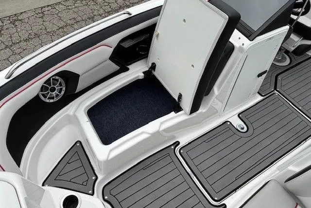 Slide: The Image of 2018 Yamaha Boats 212X interior with open storage compartment and sleek design. - 11