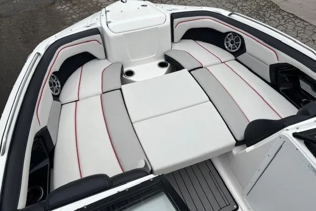Slide: The Image of 2018 Yamaha Boats 212X interior with cushioned seating and built-in speakers. - 12