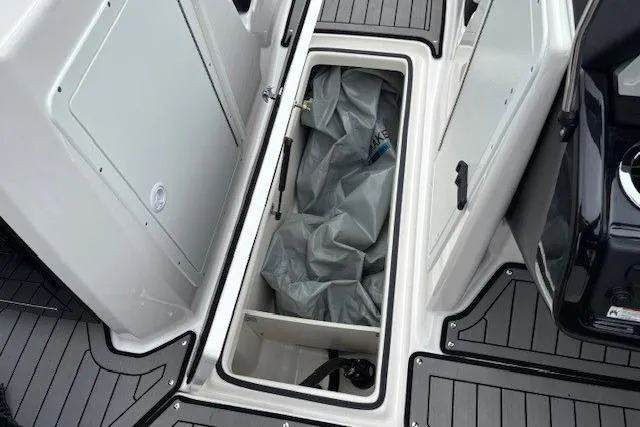 Slide: The Image of 2018 Yamaha Boats 212X storage compartment with gray interior and black trim. - 17