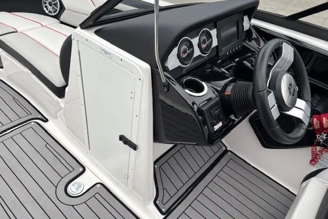 Slide: The Image of 2018 Yamaha Boats 212X cockpit with sleek dashboard and modern steering wheel design. - 19