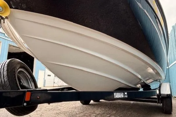 Slide: The Image of 2018 Yamaha Boats 212X on trailer, showcasing sleek hull design. - 2