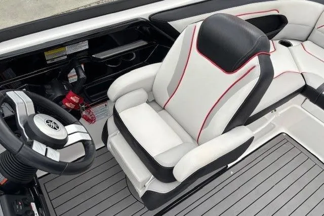Slide: The Image of 2018 Yamaha Boats 212X interior with sleek captain's chair and modern steering wheel design. - 24