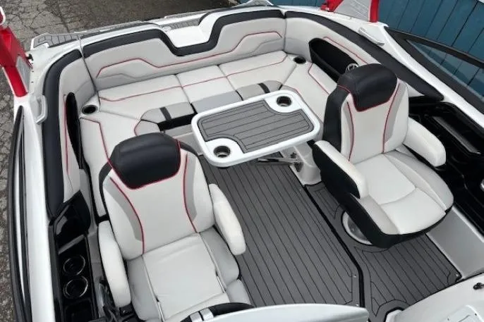 Slide: The Image of 2018 Yamaha Boats 212X interior with sleek seating and table setup. - 26