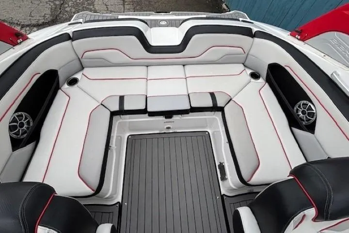 Slide: The Image of 2018 Yamaha Boats 212X interior with sleek seating, red accents, and integrated speakers. - 28