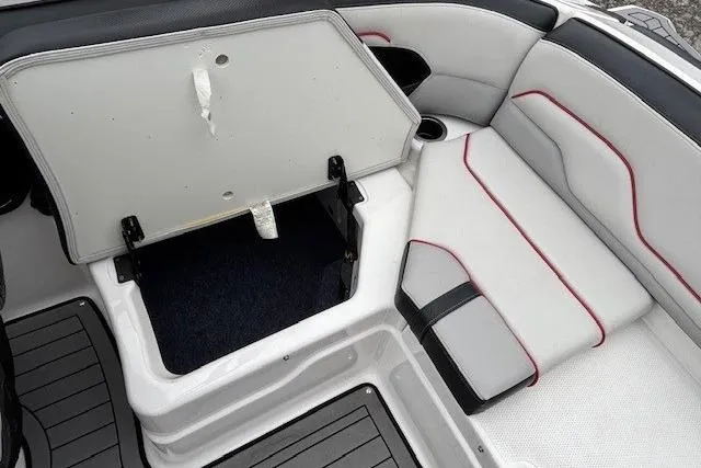 Slide: The Image of 2018 Yamaha Boats 212X interior seating with open storage compartment. - 31