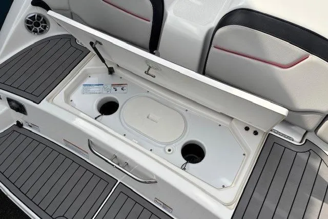 Slide: The Image of 2018 Yamaha Boats 212X storage compartment with open lid, showcasing interior details. - 35