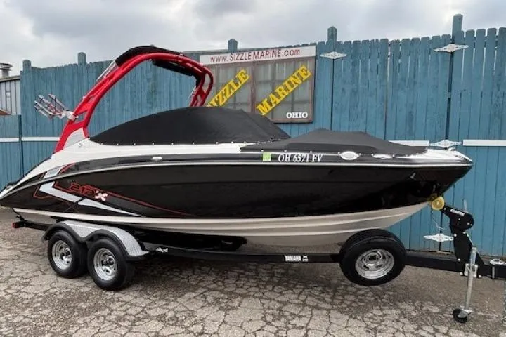 Slide: The Image of 2018 Yamaha Boats 212X on trailer, black and red design, parked at Sizzle Marine. - 40