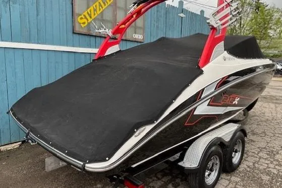 Slide: The Image of 2018 Yamaha Boats 212X covered on trailer, featuring red accents and dual axles. - 41