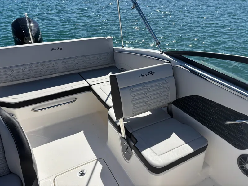 Slide: The Image of 2024 Sea Ray SPX 210 Outboard interior seating on water. - 12